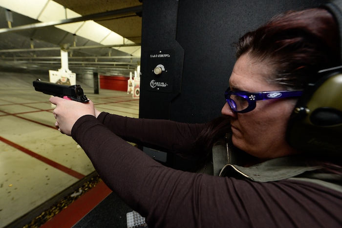 (Francisco Kjolseth  |  The Salt Lake Tribune)  NRA-certified instructor Michelle Camp takes aim as she joins other women at The Gun Vault shooting range in South Jordan. Camp, a leader of the The Well-Armed Woman chapters in Utah, encourages women to conceal carry for safety and to keep their skills sharp. Of the concealed carry permits issued by the state, only about one in five is held by a woman.
