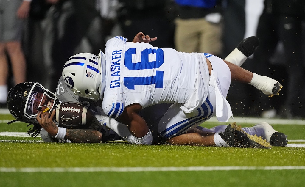 (David Zalubowski | AP) Brigham Young linebacker Isaiah Glasker, top, sacks Colorado quarterback Kaidon Salter in the second half of an NCAA college football game Saturday, Sept. 27, 2025, in Boulder, Colo.