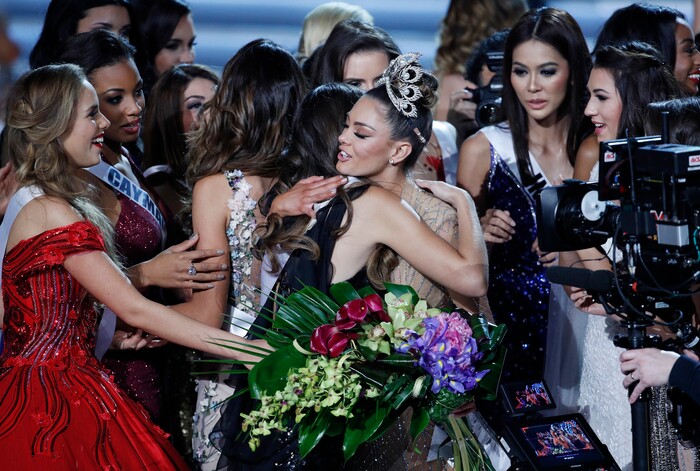 (John Locher | The Associated Press) Contestants embrace new Miss Universe Miss South Africa Demi-Leigh Nel-Peters, in crown, at the Miss Universe pageant Sunday, Nov. 26, 2017, in Las Vegas.
