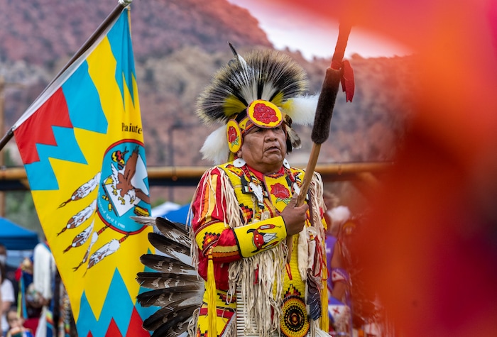 (Leah Hogsten | The Salt Lake Tribune Damon Polk, member of the San Carlos Apache and Quechan Indian Tribes leads the dancers during the Grand Entry at the 41st Annual Paiute Indian Tribe of Utah Restoration Gathering, Aug. 13, 2021 in Cedar City, Utah.