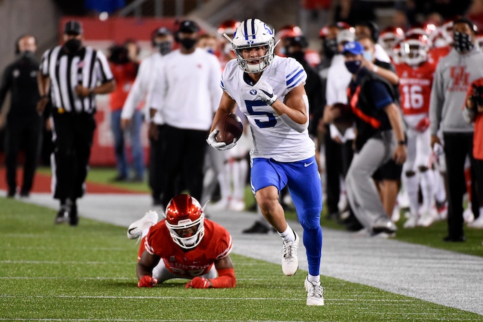 BYU wide receiver Dax Milne, right, runs for a touchdown as Houston cornerback Shaun Lewis, left, watches during the first half of an NCAA college football game, Friday, Oct. 16, 2020, in Houston. (AP Photo/Eric Christian Smith)