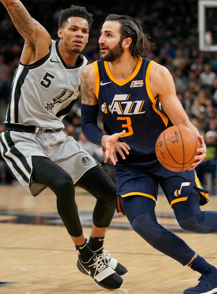 Utah Jazz's Ricky Rubio (3) drives around San Antonio Spurs' Dejounte Murray during the second half of an NBA basketball game Saturday, Feb. 3, 2018, in San Antonio. Utah won 120-111. (AP Photo/Darren Abate)