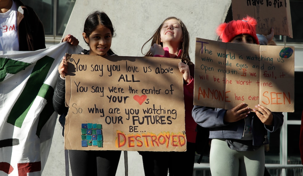 Students hold up signs outside the office of House Speaker Nancy Pelosi during a protest against climate change Friday, March 15, 2019, in San Francisco. Friday's rallies were one of the biggest international climate change actions yet, involving hundreds of thousands of students in more than 100 countries around the globe. (AP Photo/Ben Margot)