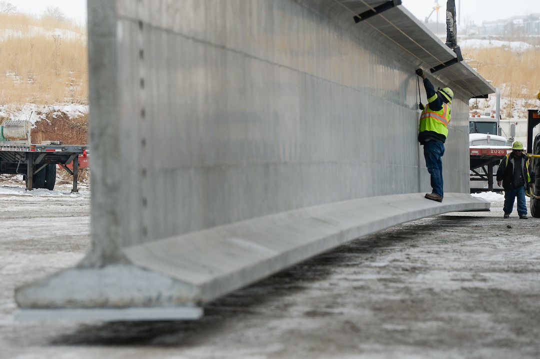 (Francisco Kjolseth  |  The Salt Lake Tribune)  UDOT gets ready to place some of the world's largest-ever bridge beams, and the largest in Utah state history with a span of 203 ft long and just over 8 ft tall, as crews load one on a truck following manufacturing at Forterra Structural Precast in Kearns on Tuesday, Dec. 11, 2018. A total of six beams will be installed in the technology corridor in Lehi later this week.