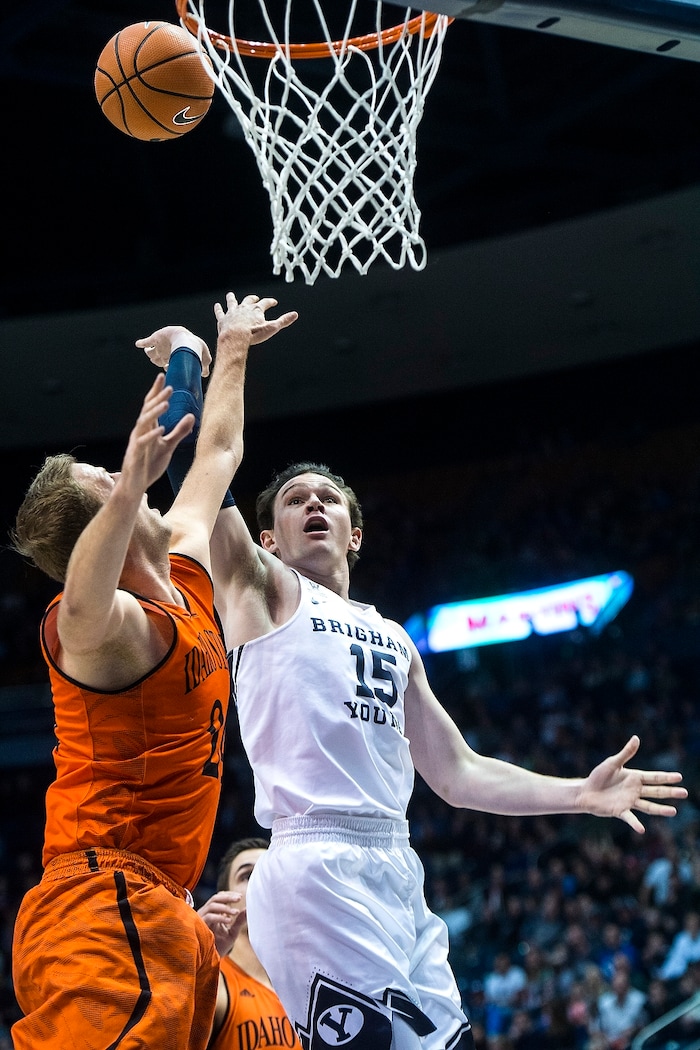 (Chris Detrick  |  The Salt Lake Tribune)  Brigham Young Cougars forward Payton Dastrup (15) shoots past Idaho State Bengals forward Blake Truman (24) during the game at the Marriott Center Thursday, December 21, 2017.  