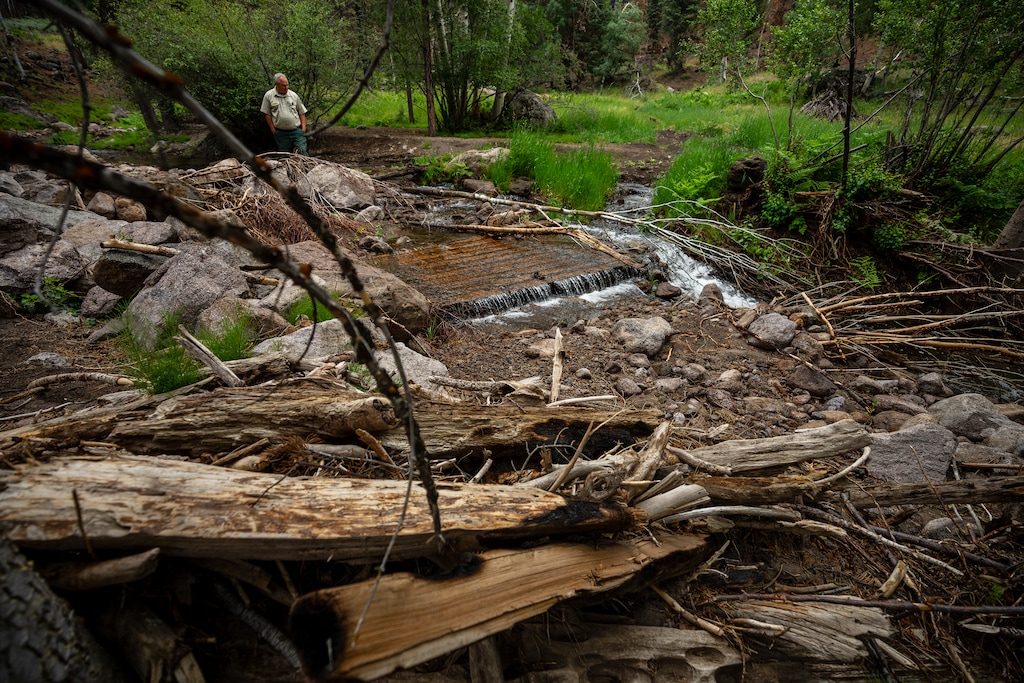 (Trent Nelson | The Salt Lake Tribune) Joe Rechsteiner looks at a foot bridge destroyed by flooding at Pine Valley Recreation Area on Wednesday, June 24, 2026.