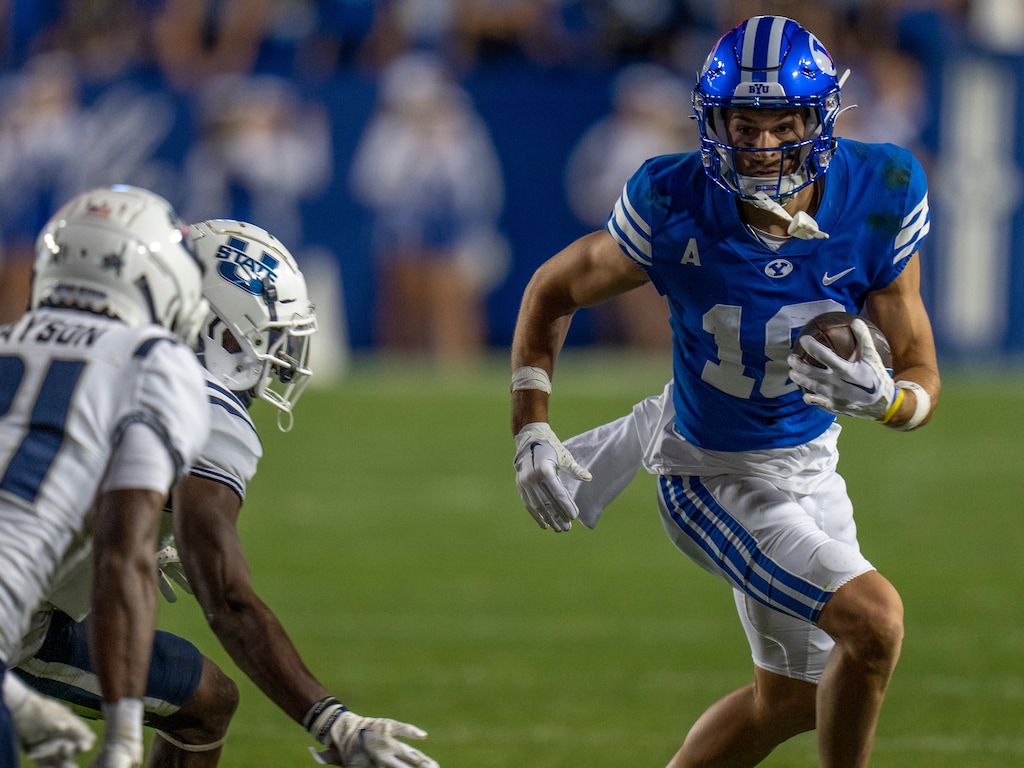(Rick Egan | The Salt Lake Tribune) Brigham Young Cougars wide receiver Gunner Romney (18) for extra yards after catching a pass, in Football action between the Brigham Young Cougars and the Utah State Aggies, at LaVell Edwards Stadium in Provo, on Thursday, Sept. 29, 2022.