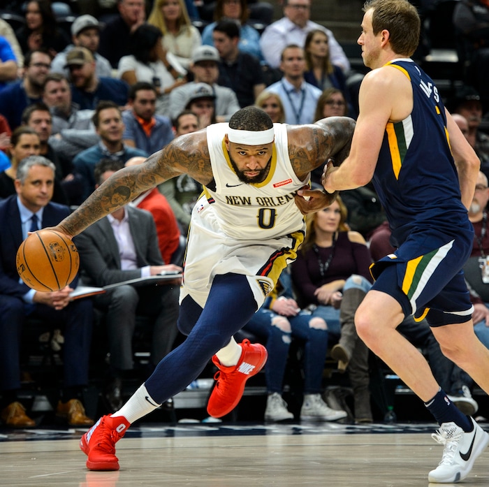 (Steve Griffin  |  The Salt Lake Tribune) New Orleans Pelicans center DeMarcus Cousins (0) drives the baseline past Utah Jazz forward Joe Ingles (2) for a slam dunk during the the Utah Jazz versus the New Orleans Pelicans NBA basketball game at the Vivint Smart Home Arena in Salt Lake City Wednesday January 3, 2018.