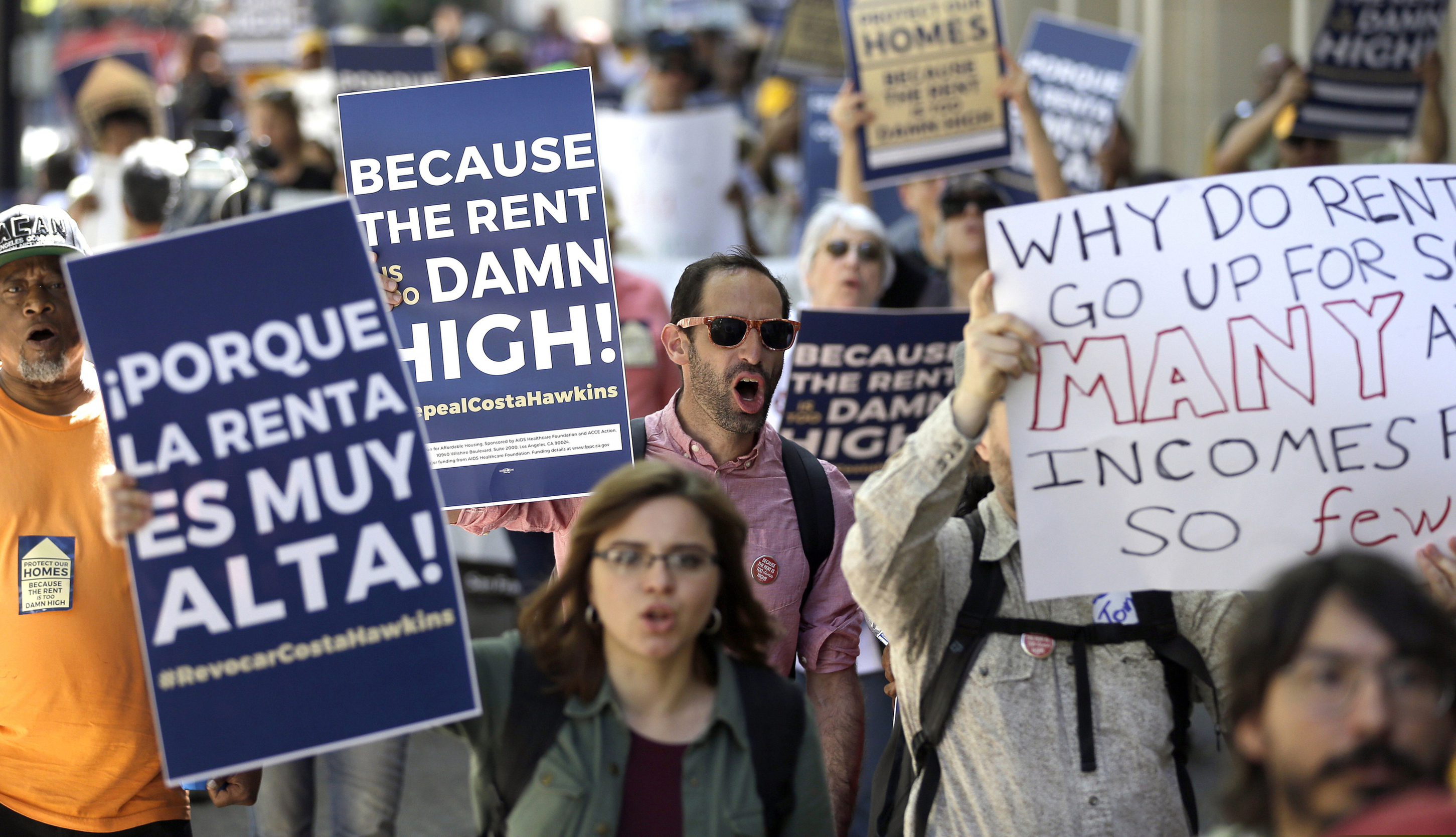 FILE — In this April 24, 2018, file photo, supporters of a rent control initiative calling for more rent control march on the Capitol in Sacramento, Calif. A new law to take effect in 2020 will bar landlords from raising yearly rent prices by more than 5% plus the cost of inflation. Landlords also won't be allowed to evict someone without a reason or refuse to rent to someone solely because they have a federal Section 8 housing voucher. (AP Photo/Rich Pedroncelli, File)