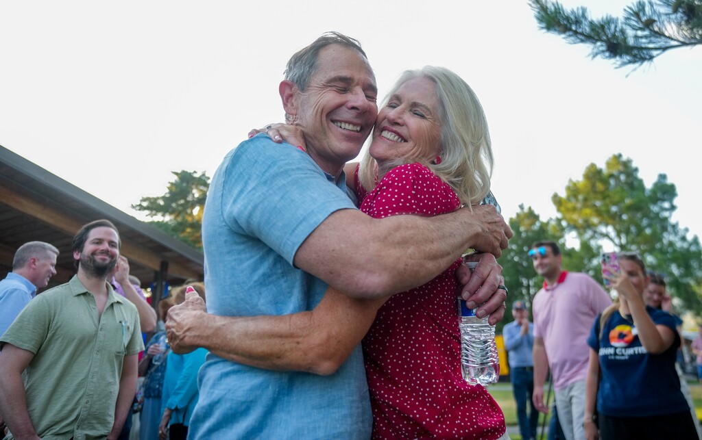 (Bethany Baker | The Salt Lake Tribune) U.S. Senate candidate Rep. John Curtis, left, embraces his wife, Sue, during a primary election party in Provo, Tuesday, June 25, 2024.