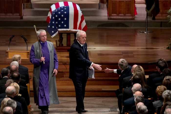 Former Canadian Prime Minister Brian Mulroney, center, shakes hands with former President George W. Bush, right, after speaking during the State Funeral for former President George H.W. Bush at the National Cathedral, Wednesday, Dec. 5, 2018, in Washington. (AP Photo/Andrew Harnik, Pool)