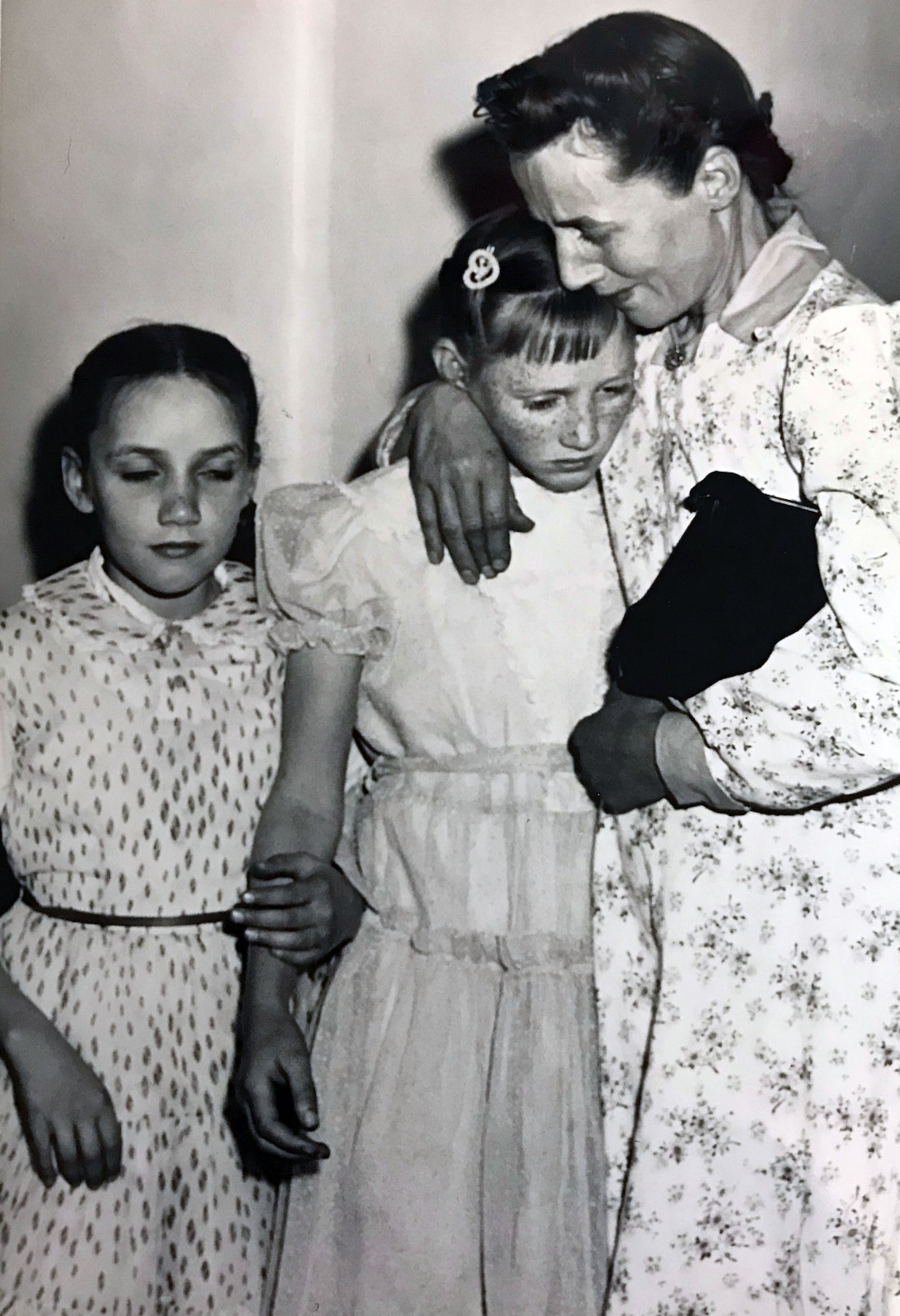 (Tribune file photo)  Vera Johnson Black comforts Elsie, 11, as Emily, 9, holds her sister's arm. Black's children were placed in state custody after the 1953 raid on Short Creek, which lead to a Utah Supreme Court case.