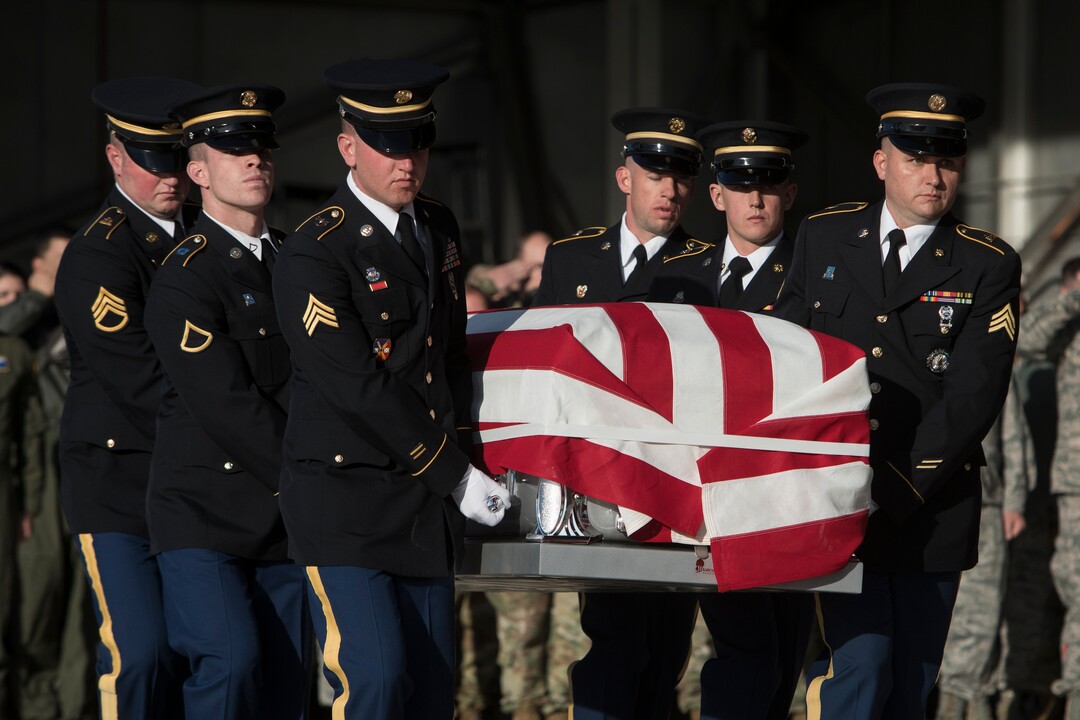 (Matt Herp  |  The Ogden Standrad Examiner/Pool) Utah National Guard Honor Guard Detail members carry a casket containing the remains of Maj. Brent R. Taylor at Roland R. Wright Air National Guard Base in Salt Lake City, Utah, on Wednesday, Nov. 14, 2018. Taylor, 39, of North Ogden, died Nov. 3, 2018, in Afghanistan of wounds sustained from small arms fire. His funeral is scheduled for Saturday, Nov. 17, in Ogden.