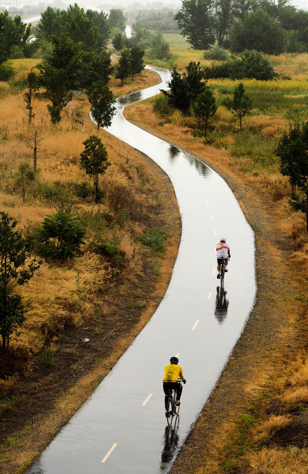 Rick Egan  |  The Salt Lake TribuneCyclists ride the Legacy Parkway Trail in Farmington on a rainy Sunday morning, July 5, 2015.