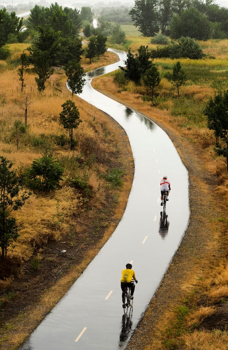 Rick Egan  |  The Salt Lake TribuneCyclists ride the Legacy Parkway Trail in Farmington on a rainy Sunday morning, July 5, 2015.