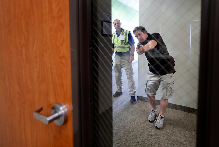 (Tony Gutierrez | AP Photo) In this July 21, 2019 photo, Police officer David Riggall, left, watches as trainee Bryan Hetherington, right, demonstrates clearing a room during a security training session at the Fellowship of the Parks campus in Haslet, Texas. An industry has sprung up following mass shootings at houses of worship around the country to train civilians to protect their churches with the techniques and equipment of law enforcement.