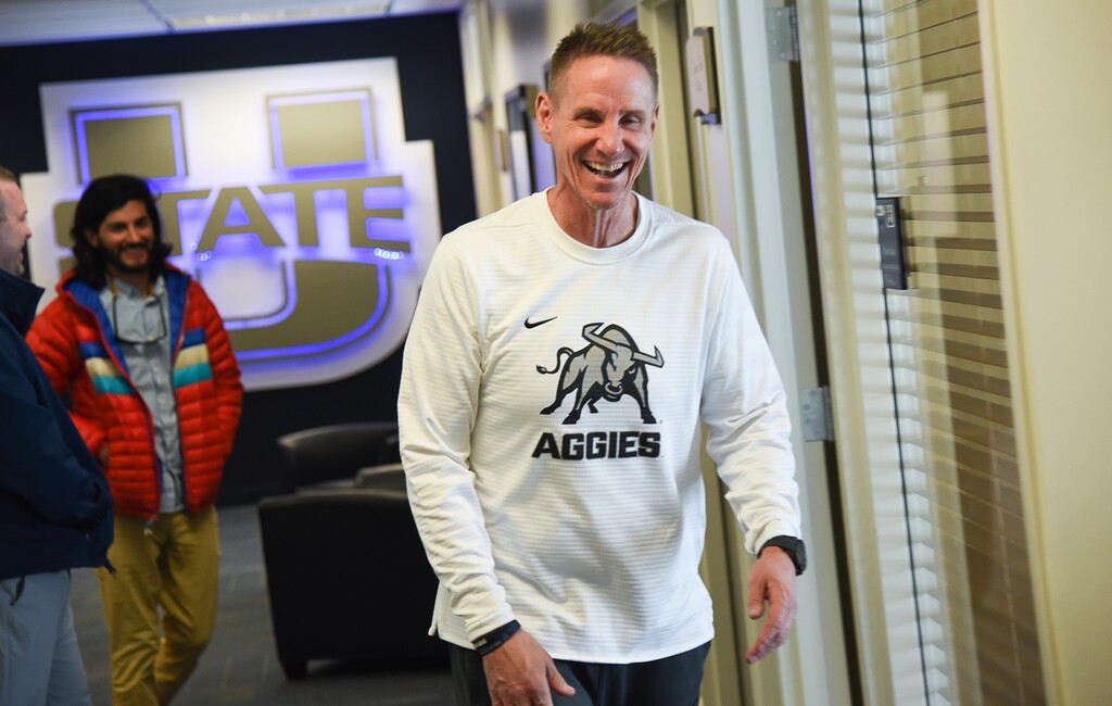 (Francisco Kjolseth  |  The Salt Lake Tribune)  USU coach Gary Andersen jokes around with staff as he walks the halls of the Jim & Carol Laub Athletics-Academic Complex.