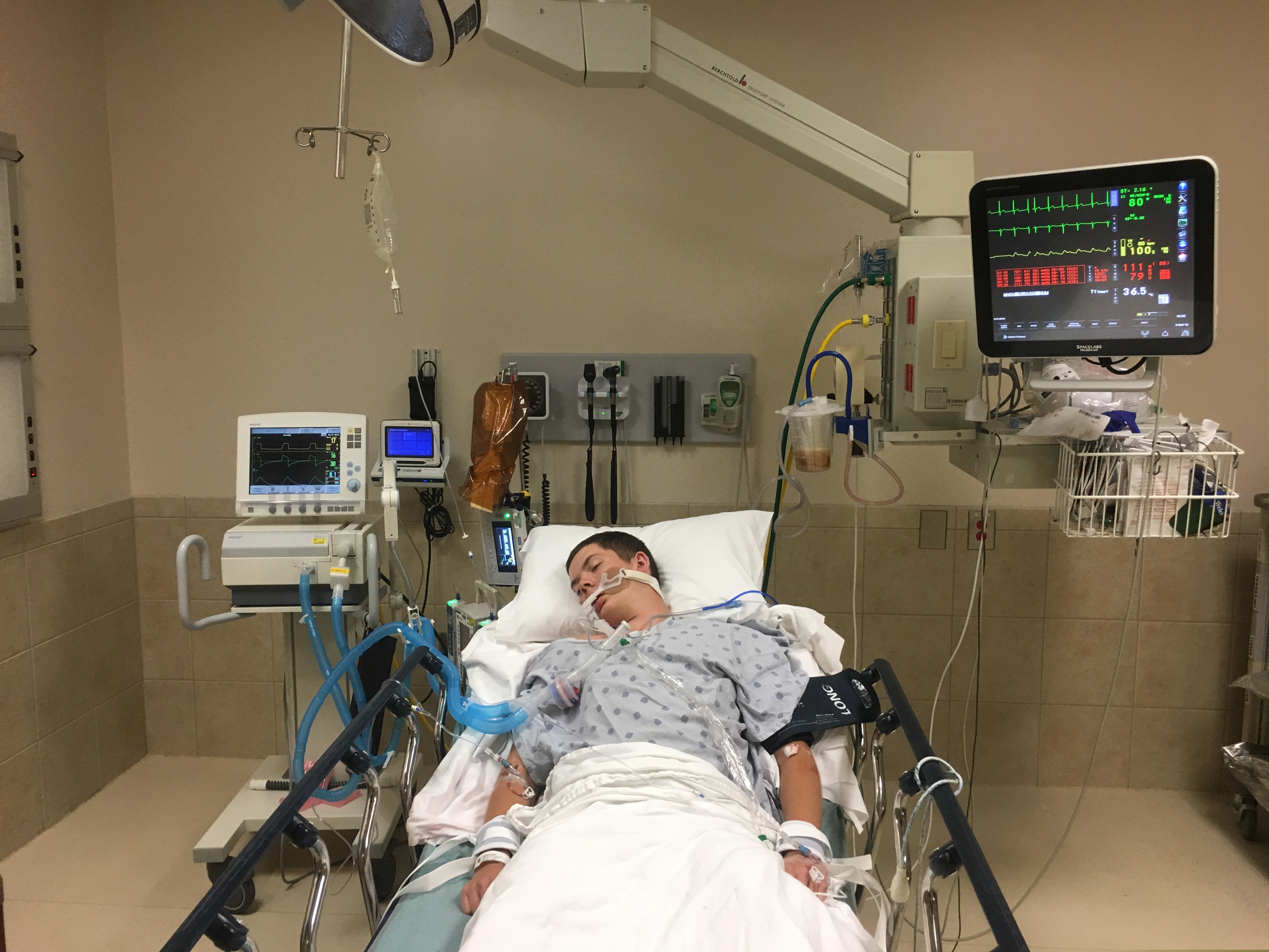 (Courtesy of Joseph Jenkins via AP)  Jay Jenkins is treated in the emergency room of the Lexington Medical Center in Lexington, S.C., in May 2018. Jenkins suffered acute respiratory failure and drifted into a coma, according to his medical records, after he says he vaped a product labeled as a smokable form of the cannabis extract CBD. Lab testing commissioned as part of an Associated Press investigation into CBD vapes showed the cartridge that Jenkins says he puffed contained a synthetic marijuana compound blamed for at least 11 deaths in Europe.
