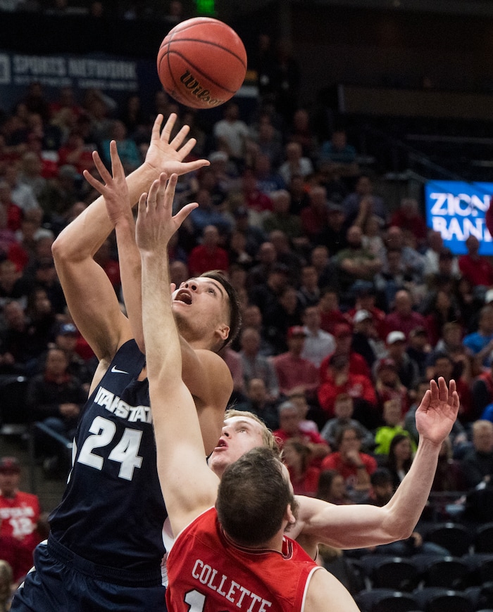 (Rick Egan  |  The Salt Lake Tribune)Utah State Aggies guard Diogo Brito (24) shoots as Utah Utes forward David Collette (13)defends, in Beehive Classic basketball action at the Vivint SmartHome Arena, Saturday, December 9, 2017.
