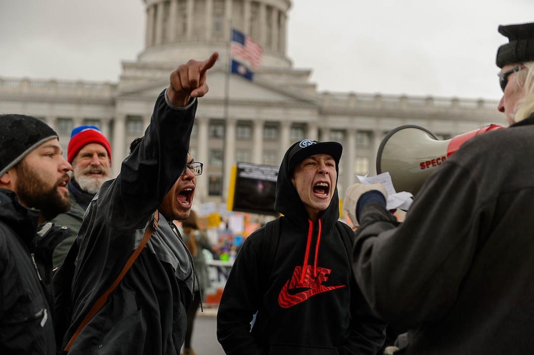 (Trent Nelson | The Salt Lake Tribune)  Protesters try to drown out a man trolling them with a megaphone at a rally against a visit by President Donald Trump, Monday December 4, 2017.