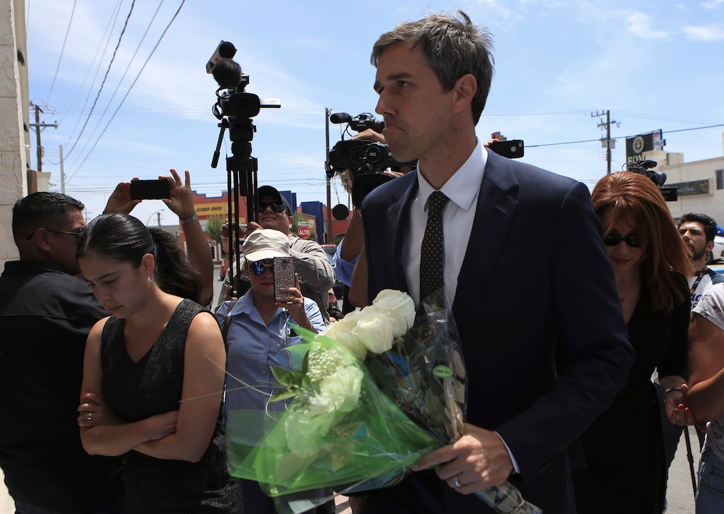 Democratic presidential candidate Beto O'Rourke arrives with flowers to the Perches funeral home in Ciudad Juarez, Mexico, Thursday, Aug. 8, 2019, to attend a service for Ivan Filiberto Manzano, one of the 22 people killed in a shooting at a Walmart in El Paso. The former El Paso congressman said he came to the border city "to remind the world that we are a binational community." (AP Photo/Christian Chavez)