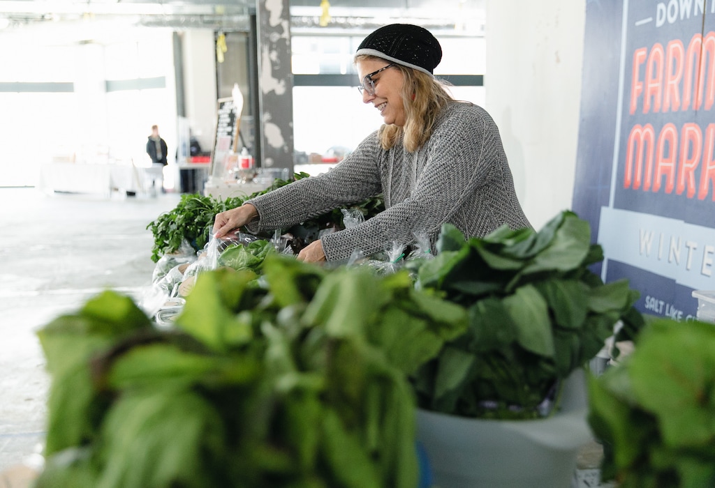 (Rachel Rydalch | The Salt Lake Tribune) Anita Murphy tends to her market stand as she sells at the Winter Market in Salt Lake City on Saturday, Feb. 26, 2022.