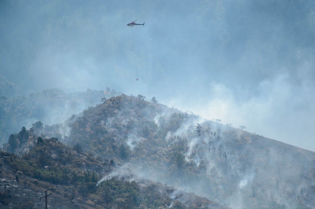 (Trent Nelson | The Salt Lake Tribune) A helicopter makes drops on a wildfire east of Tooele, Friday, July 27, 2018.