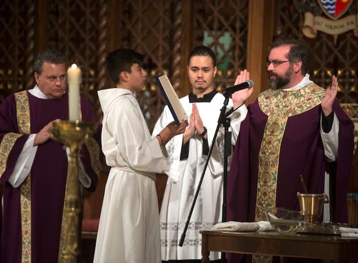 (Rick Egan | The Salt Lake Tribune) The Reverend Christopher P. Gray, blesses the ashes, during the Ash Wednesday Mass, at the Cathedral of The Madeleine, Wednesday, Feb. 14, 2018.