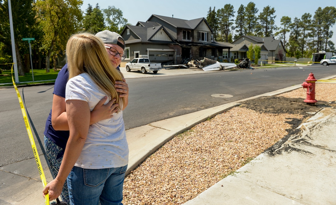 Leah Hogsten  |  The Salt Lake Tribune   Joslyn Youd, 21, gets a hug from her Aunt Nikki Ewell outside the house at 584 E. East Canyon Road in Payson where Joslyn's father, Duane "Rhedd" Youd, 47, crashed a plane about 2:30 a.m., Monday, August 13, 2018. Youd died in the plane crash. Firefighters arrived to find the home engulfed in flames. The two people inside the home escaped through the back of the home and were uninjured. Youd had been booked into the Utah County Jail about 7:30 p.m. Sunday after being suspected of assaulting his wife. He bailed out of jail; returned to the home with a police officer about midnight to retrieve belongings and his truck; and left without incident.