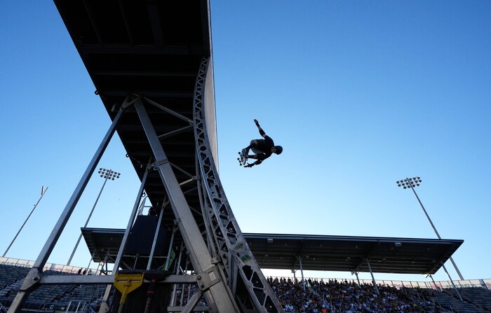(Francisco Kjolseth | The Salt Lake Tribune) Skaters go big as they are silhouetted in the late evening sun during Tony Hawk’s Vert Alert, a big-air skateboarding competition at the Utah Sate Fairpark on Friday, Aug. 26, 2022. 
