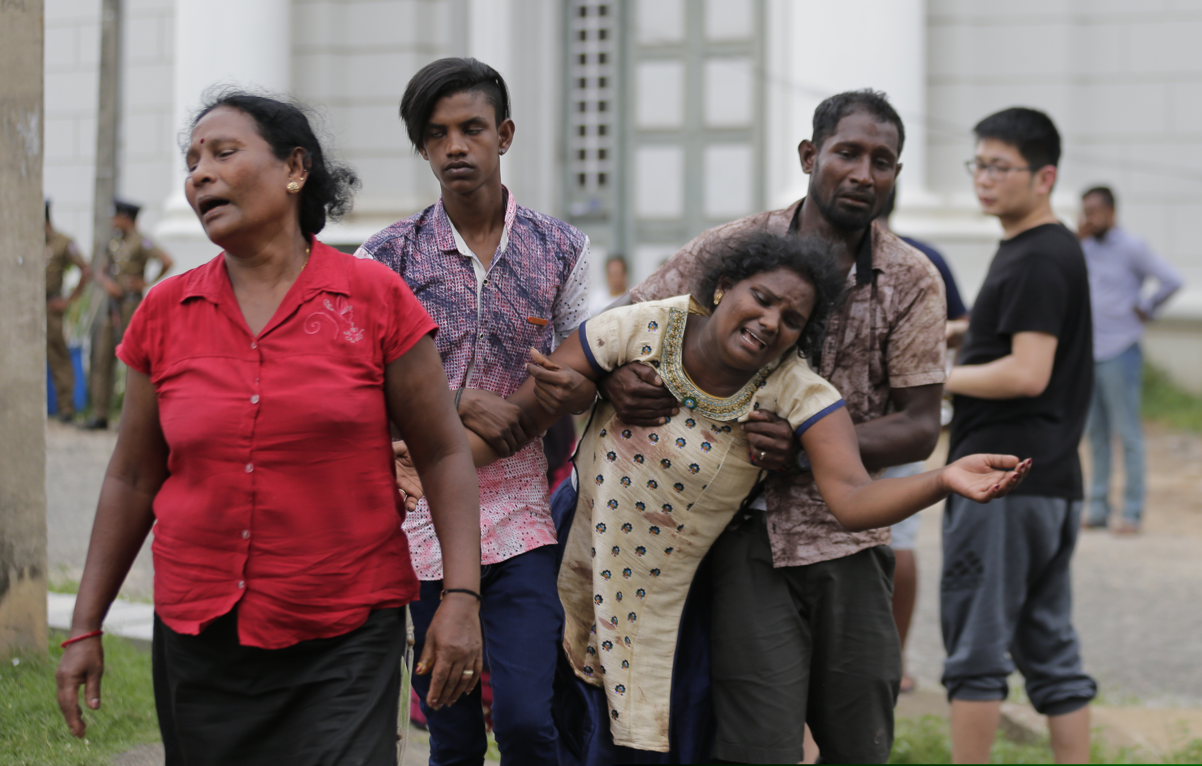 Relatives of a blast victim grieve outside a morgue in Colombo, Sri Lanka, Sunday, April 21, 2019.  More than hundred were killed and hundreds more hospitalized with injuries from eight blasts that rocked churches and hotels in and just outside of Sri Lanka's capital on Easter Sunday, officials said, the worst violence to hit the South Asian country since its civil war ended a decade ago. (AP Photo/Eranga Jayawardena)