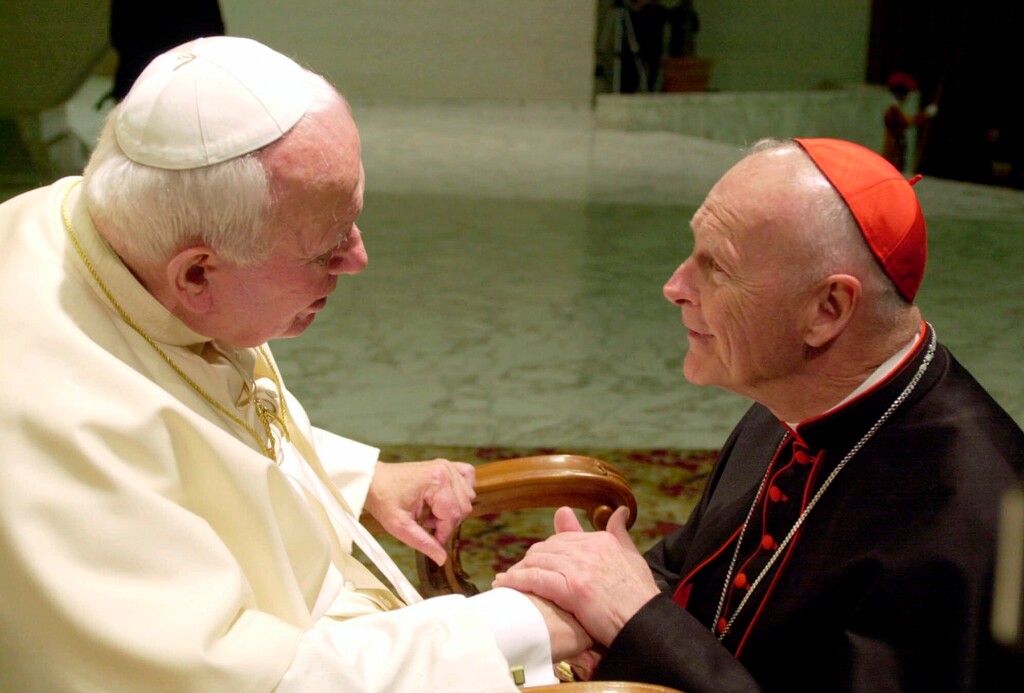 (Massimo Sambucetti | AP file photo) U.S. Cardinal Theodore Edgar McCarrick, archbishop of Washington, D.C., shakes hands with Pope John Paul II at the Vatican, Feb. 23, 2001. A report by the Vatican released Tuesday, Nov. 10, 2020 implicates Pope John Paul II in elevating McCarrick despite allegations of sexual misconduct.