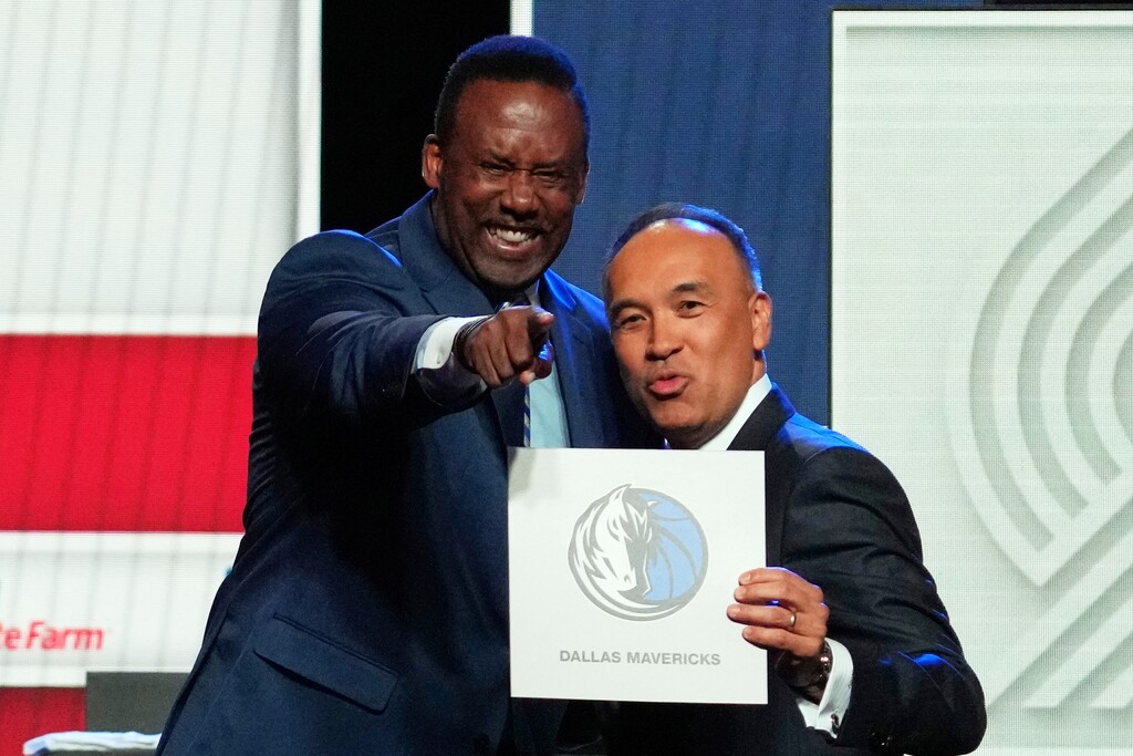 (Nam Y. Huh | AP) Dallas Mavericks' Rolando Blackman, left, and NBA Deputy Commissioner Mark Tatum, right, pose for photos after Tatum announced that the Mavericks had won the first pick in the NBA basketball draft lottery in Chicago, Monday, May 12, 2025.
