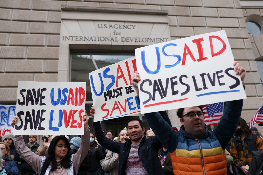 (Tierney L. Cross | The New York Times) People demonstrate in support of of the U.S. Agency for International Development outside its headquarters in Washington, on Monday, Feb. 3, 2025. The U.S. Agency for International Development is in crisis as workers report being locked out, adding to the growing sense that President Trump will dismantle the government’s lead humanitarian aid agency.