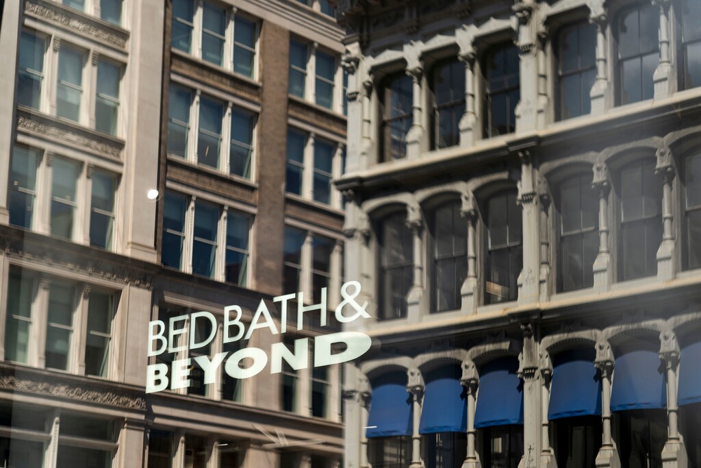(Karsten Moran | The New York Times) Bed Bath & Beyond sinage is seen through a window in New York, April 24, 2023. Overstock, which last week paid $21.5 million to acquire the bankrupt retailerÕs intellectual property, said on Wednesday, June 28, that it would start operating its website under the Bed Bath & Beyond name.