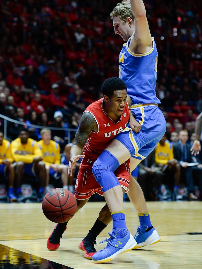 (Francisco Kjolseth  |  The Salt Lake Tribune)  Utah Utes guard Justin Bibbins (1) goes up against UCLA Bruins center Thomas Welsh (40) as the University of Utah hosts UCLA in NCAA basketball at the Huntsman Center in Salt Lake City, Thursday, Feb. 22, 2018.