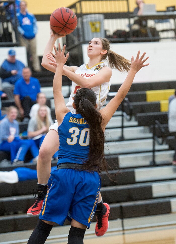 (Rick Egan  |  The Salt Lake Tribune)   Judge Memorial guard Cicely Foley (25) goes in for a lay up, as Lyandra Benn (30),  defends for San Juan, in 3A Women's basketball State playoff action Judge Memorial vs. San Juan, in Heber City, Friday, Feb. 16, 2018.