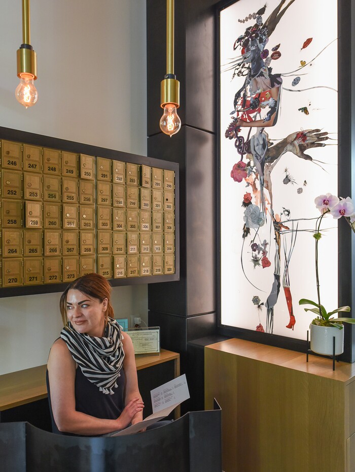 (Francisco Kjolseth  |  The Salt Lake Tribune)  Host Carmen Walker awaits patrons at Post Office Place, a new bar by the same owners as Takashi, located next door, on Tuesday, June 19, 2018. The new establishment features original art by Gary Vlasic, at right, and vintage P.O. Boxes. 