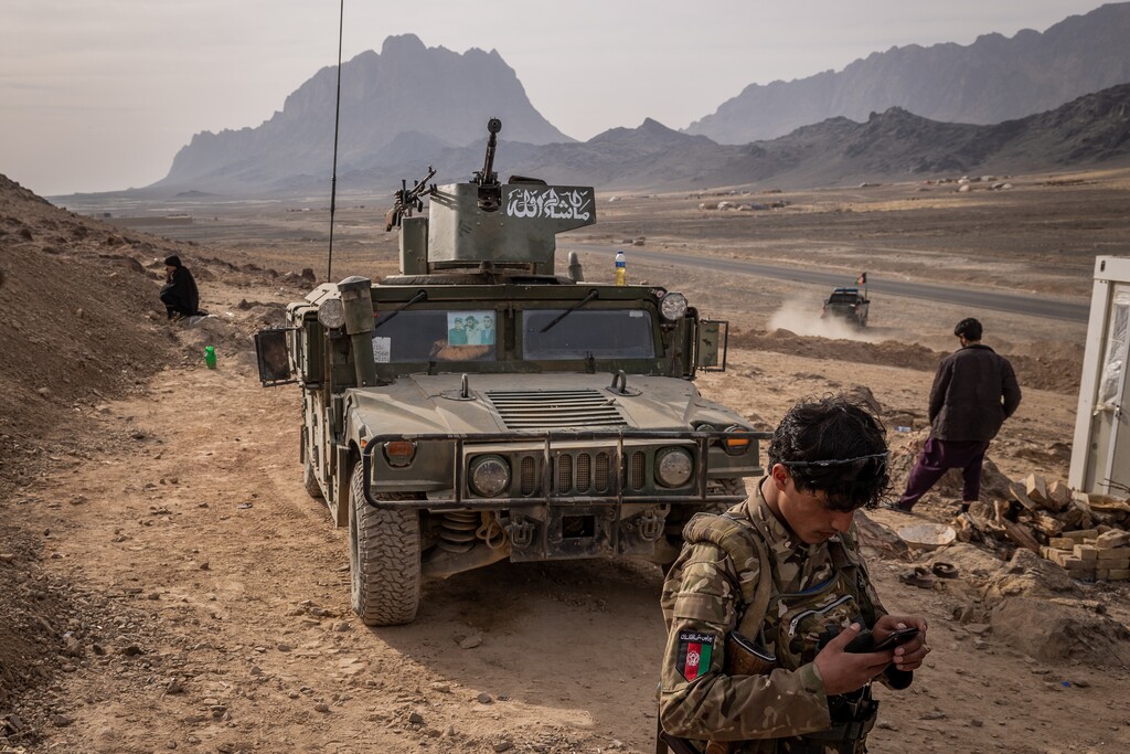 (Jim Huylebroek | The New York Times) Afghan security forces, some with uniform and others without, man a lone outpost near Panjwai, Afghanistan, Jan. 30, 2021.