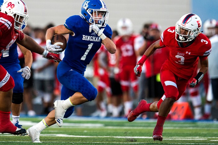 (Chris Detrick  |  The Salt Lake Tribune)  Bingham's Braedon Wissler (1) runs for a touchdown past East's Mekelee Gautavai (3) during the game at Bingham High School Friday, August 25, 2017. Bingham is winning the game 24-17 at halftime. 