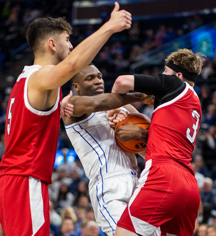 (Rick Egan | The Salt Lake Tribune)  South Dakota Coyotes guard Max Burchill (3) ants on to the ball after the whistle along with Brigham Young Cougars forward Atiki Ally Atiki (4), in basketball action between the Brigham Young Cougars and the South Dakota Coyotes, at Vivint Arena, in Salt Lake City, on Saturday, Dec. 3, 2022.
