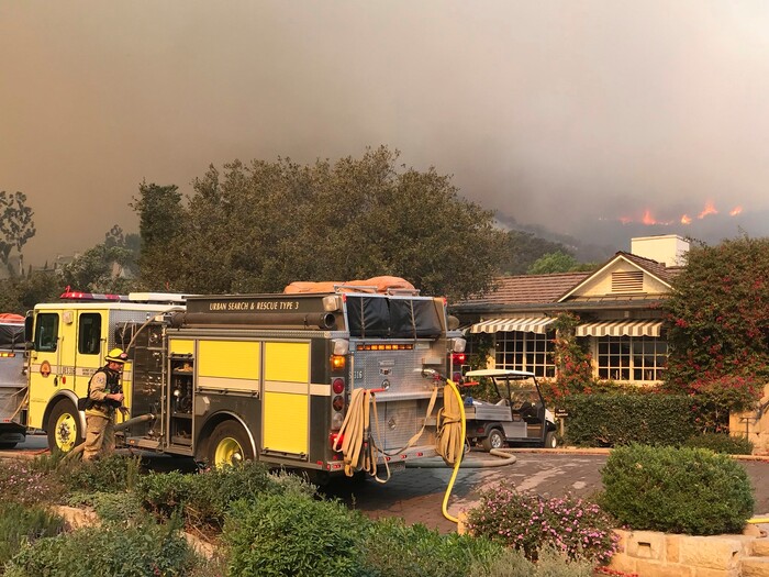 (Mike Eliason | Santa Barbara County Fire Department via AP) In this photo provided by the Santa Barbara County Fire Department, fire engines provide structure protection at the historic San Ysidro Ranch in Montecito, Calif., Saturday, Dec. 16, 2017. Santa Barbara County has issued new evacuation orders as a huge wildfire bears down on Montecito and other communities. The Office of Emergency Services announced the orders Saturday as Santa Ana winds pushed the fire close to the community.