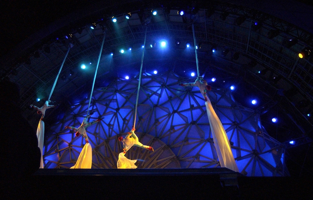 (Steve Griffin  |  Tribune file photo)  Acrobats slide down long pieces of material onto the stage at the Olympic Medals Plaza during kicking off the first night of activities in downtown Salt Lake City Feb. 9, 2002. The first medalists of the 2002 Olympics received their medals and the Dave Mathews Band performed.