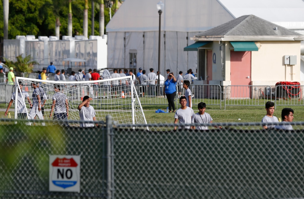 Immigrant children play outside a former Job Corps site that now houses them, Monday, June 18, 2018, in Homestead, Fla. It is not known if the children crossed the border as unaccompanied minors or were separated from family members. Wrenching scenes of migrant children being separated from their parents at the southern border are roiling campaigns ahead of midterm elections, emboldening Democrats on the often-fraught issue of immigration  (AP Photo/Wilfredo Lee)