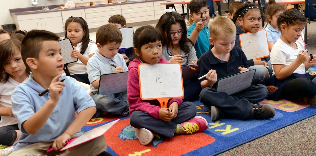 (Al Hartmann | The Salt Lake Tribune) Kindergarten students work on math problems at Riley Elementary School in 2018. It is one of 14 schools that will continue to be informally evaluated for possible boundary changes or closure, but Salt Lake City School District Superintendent Timothy Gadson has elected to push the formal process back to 2023.