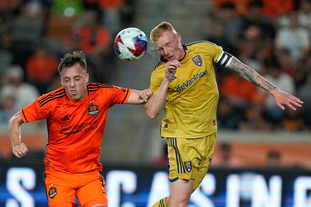 Real Salt Lake's Justen Glad, right, head the ball past Houston Dynamo's Corey Baird during the first half of an MLS soccer match Saturday, May 6, 2023, in Houston. (AP Photo/David J. Phillip)