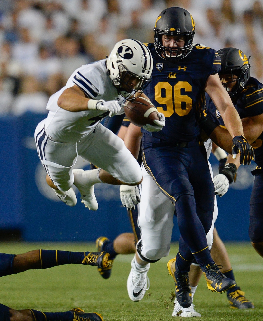 (Francisco Kjolseth  |  The Salt Lake Tribune)  Brigham Young Cougars running back Lopini Katoa (4) leaps over the California defense during the first half of the NCAA college football game, Saturday, Sept. 8, 2018, at LaVell Edwards stadium in Provo, Utah.