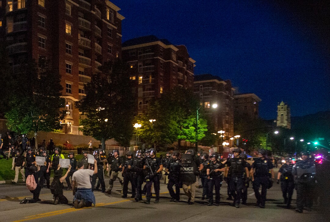 (Rick Egan  |  The Salt Lake Tribune) Marchers kneel down  as the police box in the crowd on South Temple after curfew on Monday, June 1, 2020.