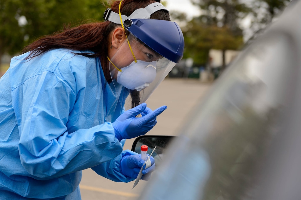 (Trent Nelson | Tribune file photo) Jessica Picaso tests a patient for COVID-19 during an event sponsored by Comunidades Unidas at Mid-Valley Health Clinic in Midvale on May 20, 2020.