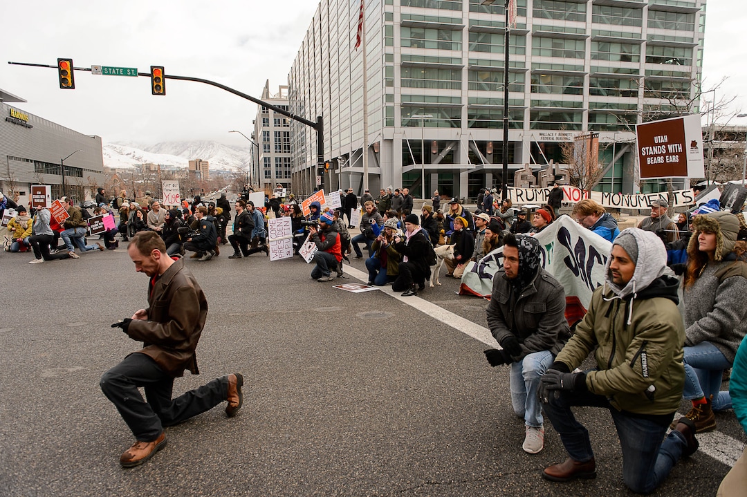(Trent Nelson | The Salt Lake Tribune)  Protesters let a bus through an intersection they had blocked off downtown after a rally against a visit by President Donald Trump, Monday December 4, 2017.